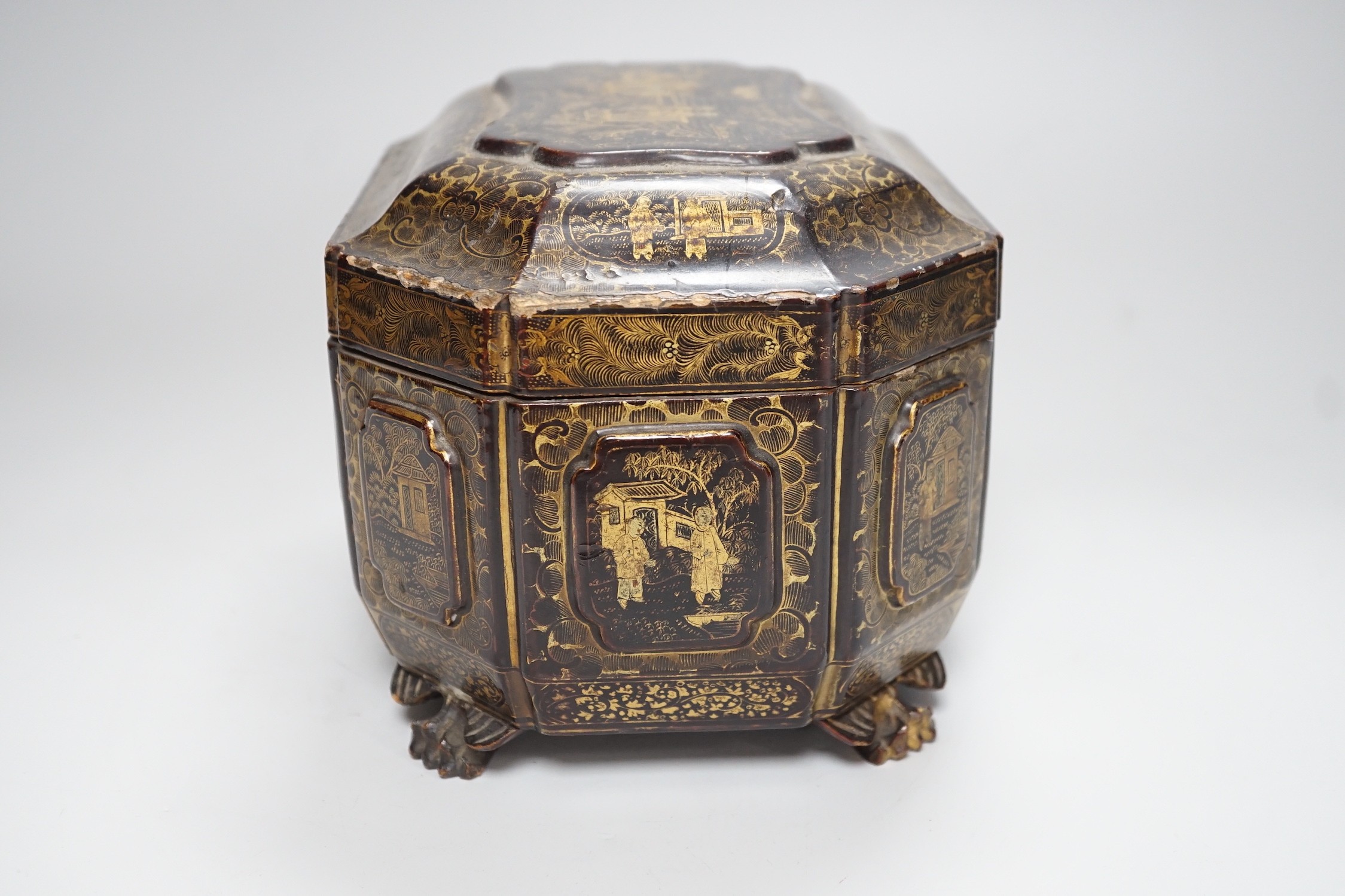 A 19th century Chinese chinoiserie lacquered sarcophagus form tea caddy, pewter lined interior with bone handles, 23cm